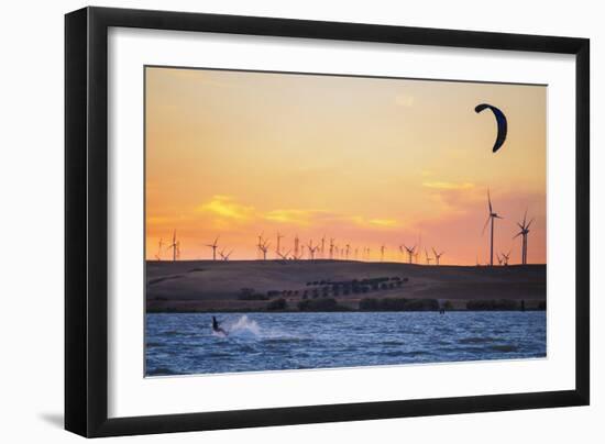 Usa, California, Rio Vista. Kiteboarder at sunset with wind farm turbines.-Merrill Images-Framed Photographic Print