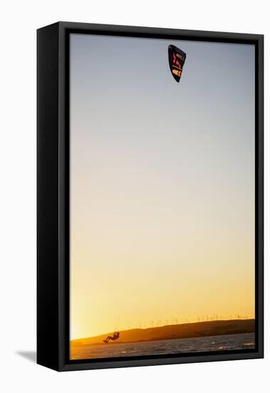 USA, California, Rio Vista, Sacramento River Delta. Kiteboarder catching air at sunset.-Merrill Images-Framed Stretched Canvas