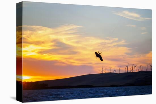 USA, California, Rio Vista, Sacramento River Delta. Kiteboarder catching air at sunset.-Merrill Images-Stretched Canvas