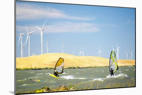 Usa, California, Rio Vista, Sacramento River Delta. Sailboarders with wind turbines.-Merrill Images-Mounted Photographic Print