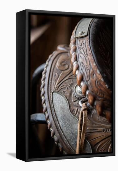 USA, Colorado, Custer County, Westcliffe. Tack room. Tooled leather western saddle.-Cindy Miller Hopkins-Framed Stretched Canvas