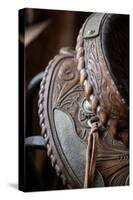 USA, Colorado, Custer County, Westcliffe. Tack room. Tooled leather western saddle.-Cindy Miller Hopkins-Stretched Canvas
