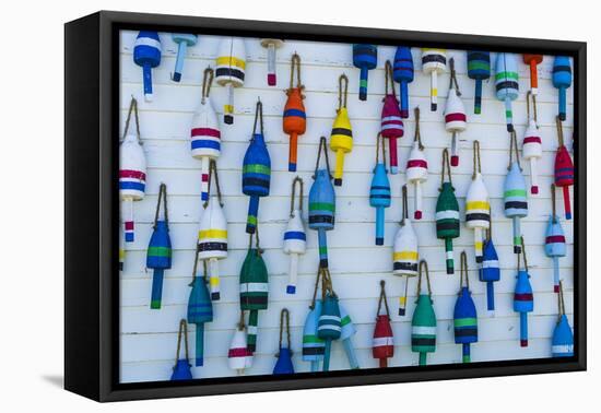 USA, Maine, Stonington, Decorative Lobster Buoys-Walter Bibikow-Framed Stretched Canvas