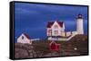 USA, Maine, York Beach, Nubble Light Lighthouse with Christmas decorations at dusk-Walter Bibikow-Framed Stretched Canvas