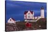 USA, Maine, York Beach, Nubble Light Lighthouse with Christmas decorations at dusk-Walter Bibikow-Stretched Canvas