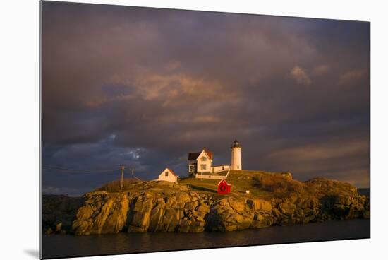 USA, Maine, York Beach, Nubble Light Lighthouse with Christmas decorations, sunset-Walter Bibikow-Mounted Premium Photographic Print