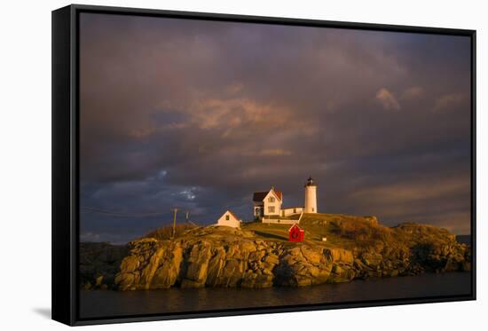 USA, Maine, York Beach, Nubble Light Lighthouse with Christmas decorations, sunset-Walter Bibikow-Framed Stretched Canvas