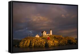 USA, Maine, York Beach, Nubble Light Lighthouse with Christmas decorations, sunset-Walter Bibikow-Framed Stretched Canvas