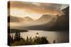 USA, Montana, Glacier NP. Sunrise pierces clouds over St. Mary Lake.-Don Grall-Stretched Canvas