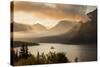 USA, Montana, Glacier NP. Sunrise pierces clouds over St. Mary Lake.-Don Grall-Stretched Canvas