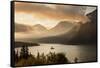 USA, Montana, Glacier NP. Sunrise pierces clouds over St. Mary Lake.-Don Grall-Framed Stretched Canvas