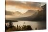 USA, Montana, Glacier NP. Sunrise pierces clouds over St. Mary Lake.-Don Grall-Stretched Canvas