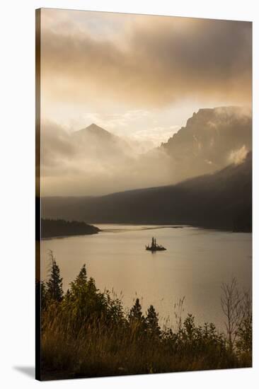 USA, Montana, Glacier NP. Sunrise pierces clouds over St. Mary Lake.-Don Grall-Stretched Canvas