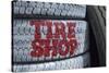 USA, Nevada. Beatty, tire shop sign painted on old tires-Kevin Oke-Stretched Canvas