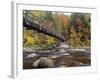Usa, New Hampshire, Lincoln, fall foliage and suspension bridge over the Pemigewasset River.-Merrill Images-Framed Photographic Print