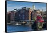 USA, New Hampshire, Portsmouth, waterfront buildings with tugboat-Walter Bibikow-Framed Stretched Canvas