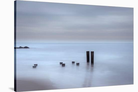 USA, New Jersey, Cape May National Seashore. Beach pilings on stormy sunrise.-Jaynes Gallery-Stretched Canvas