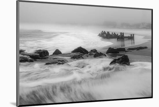 USA, New Jersey, Cape May National Seashore. Black and white of beach waves and old pier.-Jaynes Gallery-Mounted Photographic Print