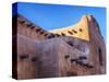 USA, New Mexico, Sant Fe, Adobe structure with protruding vigas and Snow-Terry Eggers-Stretched Canvas