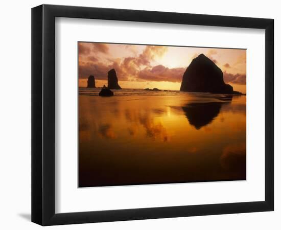 USA, Oregon, Cannon Beach Haystack Rock silhouetted at sunset.-Stuart Westmorland-Framed Photographic Print