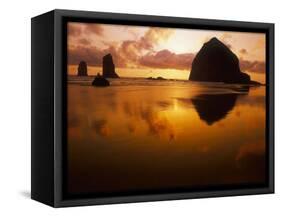 USA, Oregon, Cannon Beach Haystack Rock silhouetted at sunset.-Stuart Westmorland-Framed Stretched Canvas