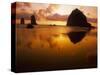 USA, Oregon, Cannon Beach Haystack Rock silhouetted at sunset.-Stuart Westmorland-Stretched Canvas