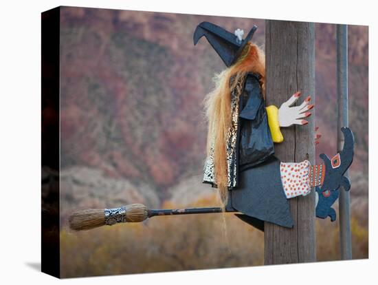 USA, Utah, Moab, Halloween witch on broomstick that crashed into pole.-Merrill Images-Stretched Canvas