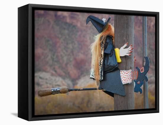 USA, Utah, Moab, Halloween witch on broomstick that crashed into pole.-Merrill Images-Framed Stretched Canvas