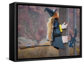 USA, Utah, Moab, Halloween witch on broomstick that crashed into pole.-Merrill Images-Framed Stretched Canvas
