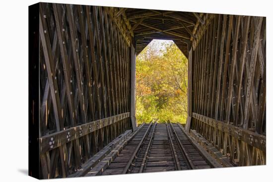 USA, Vermont, Fall foliage seen off Rt. 15, Wolcott, Fisher Covered Railroad Bridge (1908)-Alison Jones-Stretched Canvas