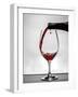 USA, Washington, Spokane. Red wine poured into wine glass creates perfect round drop,-Richard Duval-Framed Photographic Print