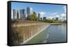 USA, Washington State, Bellevue. Pond and waterfall at Downtown Park, with skyline.-Merrill Images-Framed Stretched Canvas