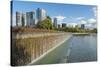 USA, Washington State, Bellevue. Pond and waterfall at Downtown Park, with skyline.-Merrill Images-Stretched Canvas