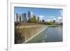 USA, Washington State, Bellevue. Pond and waterfall at Downtown Park, with skyline.-Merrill Images-Framed Photographic Print