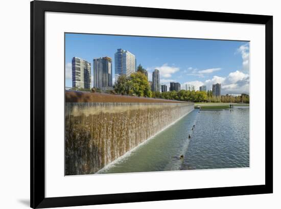 USA, Washington State, Bellevue. Pond and waterfall at Downtown Park, with skyline.-Merrill Images-Framed Photographic Print