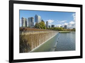 USA, Washington State, Bellevue. Pond and waterfall at Downtown Park, with skyline.-Merrill Images-Framed Photographic Print