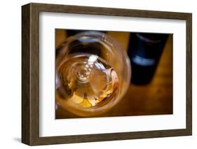 USA, Washington State, Seattle. Wine bottles are reflected in a glass of L'Orange, a Pinot Gris mad-Richard Duval-Framed Photographic Print