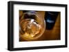 USA, Washington State, Seattle. Wine bottles are reflected in a glass of L'Orange, a Pinot Gris mad-Richard Duval-Framed Photographic Print