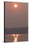 USA, Washington State. Two people in sailboat. Smoky skies from wildfires create eerie sunset-Trish Drury-Stretched Canvas