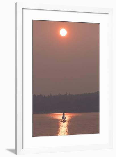USA, Washington State. Two people in sailboat. Smoky skies from wildfires create eerie sunset-Trish Drury-Framed Photographic Print