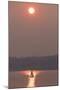 USA, Washington State. Two people in sailboat. Smoky skies from wildfires create eerie sunset-Trish Drury-Mounted Photographic Print