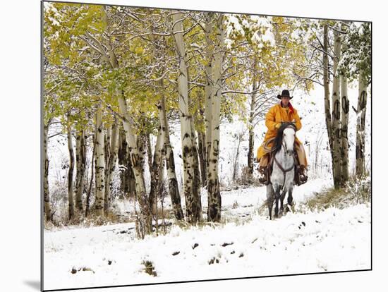 USA, Wyoming, Shell, Big Horn Mountains, Cowboys riding through with fresh snowfall-Terry Eggers-Mounted Photographic Print