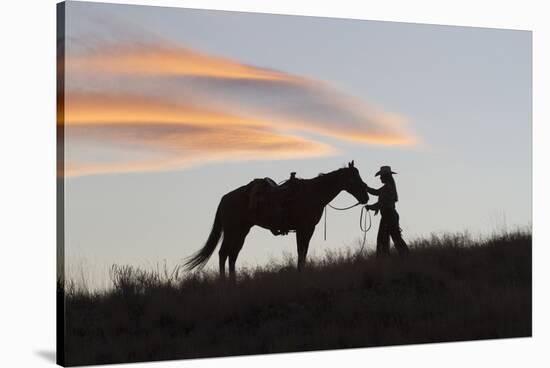 USA, Wyoming, Shell, The Hideout Ranch, Silhouette of Cowgirl with Horse at Sunset-Hollice Looney-Stretched Canvas