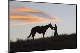 USA, Wyoming, Shell, The Hideout Ranch, Silhouette of Cowgirl with Horse at Sunset-Hollice Looney-Mounted Photographic Print