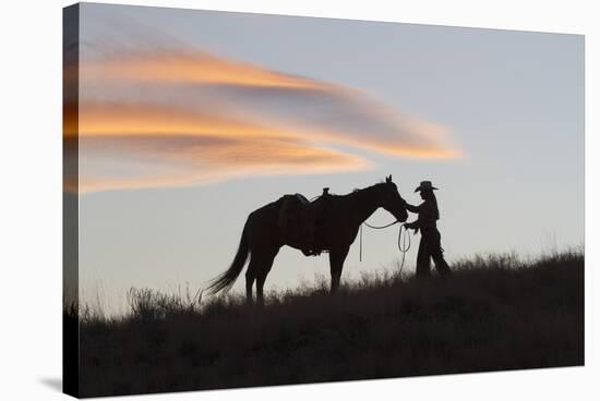 USA, Wyoming, Shell, The Hideout Ranch, Silhouette of Cowgirl with Horse at Sunset-Hollice Looney-Stretched Canvas