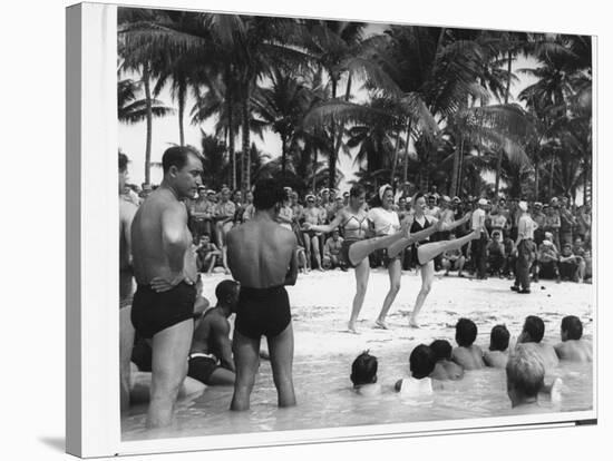 USO Chorus Girls Doing High-Kicks in Swimsuits During Impromptu Song and Dance on Beach-Peter Stackpole-Stretched Canvas