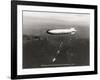 USS Macon over the Golden Gate and Pacific Fleet, 1934-Clyde Sunderland-Framed Art Print