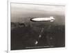 USS Macon over the Golden Gate and Pacific Fleet, 1934-Clyde Sunderland-Framed Art Print