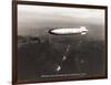 USS Macon over the Golden Gate and Pacific Fleet, 1934-Clyde Sunderland-Framed Art Print