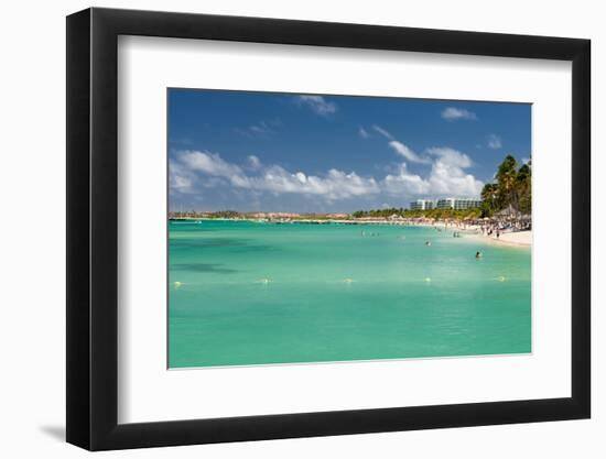 Vacationers along Palm Beach in Aruba-raphoto-Framed Photographic Print